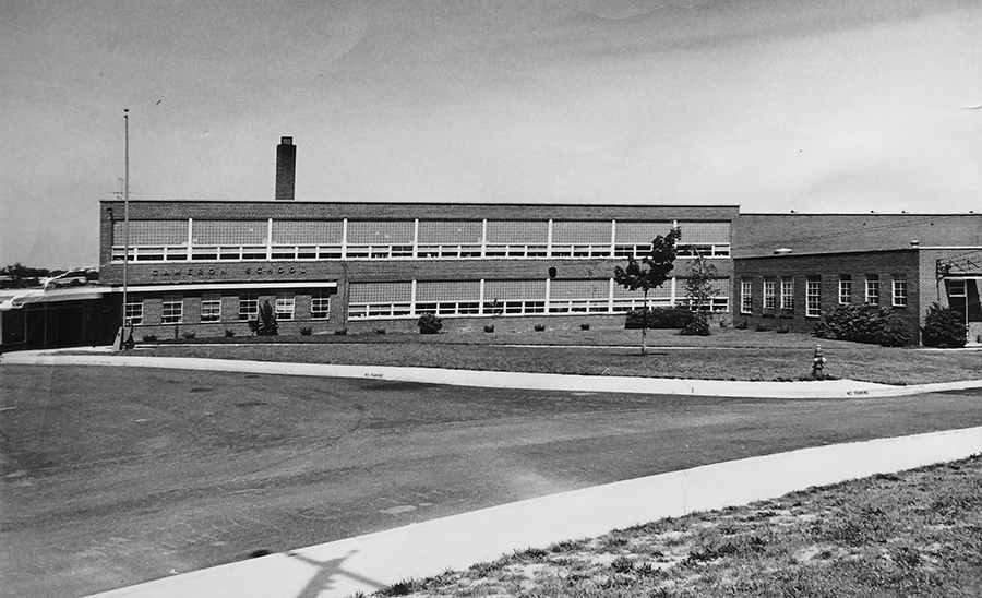 Black and white photograph of the original main entrance of Cameron Elementary School. A new section has been added behind the cafeteria.