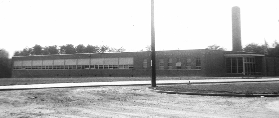Black and white photograph of Drew-Smith Elementary School. The building is a single-story concrete structure with a brick veneer. It has much fewer classrooms and fewer amenities than the schools built for white children during this time period.